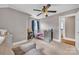 Bedroom featuring neutral tones, soft carpet, ceiling fan and direct access to the bathroom at 3101 Hickory Hwy, Statesville, NC 28677