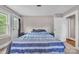 Bedroom with a blue striped bedspread, window, door and neutral colored walls at 3101 Hickory Hwy, Statesville, NC 28677