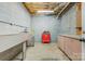 Unfinished basement with concrete block walls, drop ceiling, and a workbench area at 3125 Arden Way, Claremont, NC 28610
