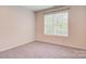 This bedroom features neutral walls, carpet, and a large window at 3125 Arden Way, Claremont, NC 28610