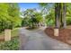A charming circular driveway leads to a home framed by mature trees and manicured landscaping for enhanced curb appeal at 3125 Arden Way, Claremont, NC 28610