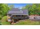Back exterior view of this home with a solar panel, elevated deck, and pool at 3125 Arden Way, Claremont, NC 28610