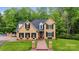 Stunning exterior showcasing a well-kept lawn, brick facade, dark shutters, and an inviting walkway, near the pool at 3125 Arden Way, Claremont, NC 28610