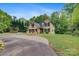 Charming two-story home featuring manicured lawn, circular driveway, and mature trees at 3125 Arden Way, Claremont, NC 28610