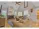 Bright living room with stone fireplace, hardwood floors, and large windows at 3125 Arden Way, Claremont, NC 28610