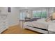 Bright primary bedroom boasts wood floors, white furniture, and a doorway to a balcony at 3125 Arden Way, Claremont, NC 28610