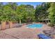 Backyard features a lovely in-ground pool with comfortable patio furniture around the fenced area at 3125 Arden Way, Claremont, NC 28610