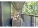 Cozy balcony with comfortable seating, a decorative tree, and views of lush greenery at 3538 Saker Ln, Charlotte, NC 28211