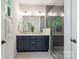 Contemporary bathroom featuring double vanity, tiled shower, and modern fixtures at 3538 Saker Ln, Charlotte, NC 28211