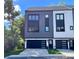 Modern townhouse featuring a sleek design with a two-car garage and contemporary black and white color scheme at 3538 Saker Ln, Charlotte, NC 28211