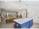 Open kitchen with a large center island, modern lighting, stainless appliances, and seamless flow into the dining area at 3538 Saker Ln, Charlotte, NC 28211