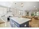 Well-designed kitchen featuring a central island, pendant lighting, white cabinets, and stainless steel appliances at 3538 Saker Ln, Charlotte, NC 28211