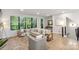 Spacious living room with lots of natural light, light wood floors, and an open floor plan at 3538 Saker Ln, Charlotte, NC 28211