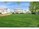 Expansive backyard featuring a well-maintained lawn and a deck, ideal for outdoor activities at 4015 Amber Leigh Way Dr, Charlotte, NC 28269