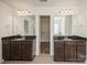 Large primary bathroom featuring granite countertops, dual sinks, mirrors, tile floors, and access to a walk-in closet at 4015 Amber Leigh Way Dr, Charlotte, NC 28269