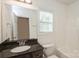 Bathroom features granite countertops, a mirror, a window, and a shower at 4015 Amber Leigh Way Dr, Charlotte, NC 28269