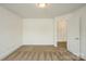 Carpeted bedroom has neutral colors and a doorway leading to another room at 4015 Amber Leigh Way Dr, Charlotte, NC 28269