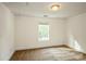 This bedroom has neutral-colored carpet, a window, and white walls at 4015 Amber Leigh Way Dr, Charlotte, NC 28269