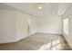Large bedroom featuring neutral carpet, tray ceiling and access to an en-suite bathroom with a glass shower at 4015 Amber Leigh Way Dr, Charlotte, NC 28269