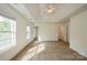 A bright bedroom features a trey ceiling, neutral carpet, natural light, and access to an en-suite bathroom and closet at 4015 Amber Leigh Way Dr, Charlotte, NC 28269