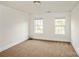 Neutral colored carpeted bedroom with bright light from the two windows at 4015 Amber Leigh Way Dr, Charlotte, NC 28269