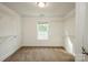 A white walk-in closet with a window, white wire shelving, and neutral carpet at 4015 Amber Leigh Way Dr, Charlotte, NC 28269