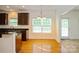 Bright dining area with hardwood floors, chandelier, and access to the kitchen and porch at 4015 Amber Leigh Way Dr, Charlotte, NC 28269