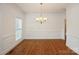 Formal dining room with hardwood floors, chandelier, and ample natural light at 4015 Amber Leigh Way Dr, Charlotte, NC 28269