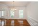 Elegant dining area with hardwood floors, large windows, and classic chandelier at 4015 Amber Leigh Way Dr, Charlotte, NC 28269