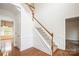 A home entryway featuring hardwood floors, stairs with white railings, and neutral walls at 4015 Amber Leigh Way Dr, Charlotte, NC 28269