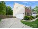 Spacious two-car garage with extended driveway and lush landscaping at 4015 Amber Leigh Way Dr, Charlotte, NC 28269