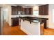 A modern kitchen with granite countertops, stainless steel appliances, and dark wood cabinetry at 4015 Amber Leigh Way Dr, Charlotte, NC 28269