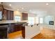 Kitchen featuring dark wood cabinetry, granite countertops, stainless appliances, and hardwood flooring at 4015 Amber Leigh Way Dr, Charlotte, NC 28269