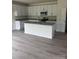 Modern kitchen with white cabinets, gray countertops, and a central island at 405 Webb Rd, Shelby, NC 28152