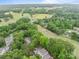 Aerial view showcasing a suburban neighborhood with homes, trees, and a golf course in the background at 407 Eastwood Dr, Salisbury, NC 28146