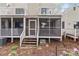 Back exterior of a home with two screened-in porches and a small step-down wood staircase at 407 Eastwood Dr, Salisbury, NC 28146