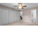 Bedroom features neutral walls, a ceiling fan, and access to an ensuite bathroom at 407 Eastwood Dr, Salisbury, NC 28146