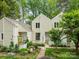 Inviting front of a townhome featuring a well-maintained garden and classic neutral siding at 407 Eastwood Dr, Salisbury, NC 28146