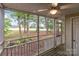 View from a screened porch with wooden floors looking onto a large backyard filled with trees at 407 Eastwood Dr, Salisbury, NC 28146