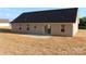 Back exterior view of single story house, showing vinyl siding and small concrete patio at 4304 Fletcher Funderburk Rd, Lancaster, SC 29720
