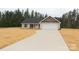 Charming single-story home features a two-car garage, concrete driveway, and newly landscaped yard at 4304 Fletcher Funderburk Rd, Lancaster, SC 29720