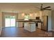 Bright kitchen features white cabinetry, granite countertops, stainless appliances, and eat-in dining at 4304 Fletcher Funderburk Rd, Lancaster, SC 29720