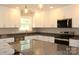 Beautiful kitchen features granite counters, stainless appliances, and bright white cabinetry at 4304 Fletcher Funderburk Rd, Lancaster, SC 29720