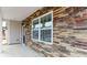 Close-up showcases a stone facade, large windows, and a covered porch with stone accents and a blue front door at 4615 Harris Elliot Rd, Lincolnton, NC 28092