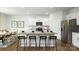 Well-lit kitchen featuring a spacious island with bar stool seating, modern appliances, and sleek white cabinetry at 4615 Harris Elliot Rd, Lincolnton, NC 28092