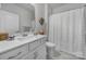 Clean bathroom featuring a single vanity, a built-in toilet and shower with bright neutral paint at 5101 Helmsworth Dr, Waxhaw, NC 28173