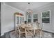 Inviting dining room with round wooden table, elegant chandelier, and natural light at 5101 Helmsworth Dr, Waxhaw, NC 28173