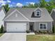 Charming single-story home featuring a two-car garage and well-manicured front yard at 5101 Helmsworth Dr, Waxhaw, NC 28173