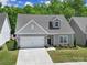 Charming, single-Gathering home boasting a well-maintained lawn, attached garage, and desirable curb appeal at 5101 Helmsworth Dr, Waxhaw, NC 28173