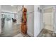 Inviting hallway featuring hardwood floors and an antique grandfather clock, with open access to the dining room at 5101 Helmsworth Dr, Waxhaw, NC 28173